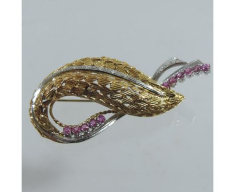 An 18 carat gold ruby and diamond brooch, of asymmetrical design