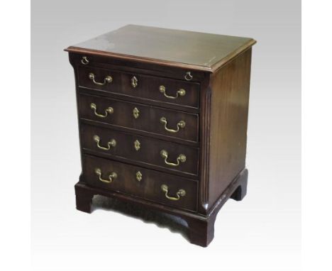 A George III mahogany bachelor's chest, fitted with a brushing slide, over four long graduated drawers, between canted angles