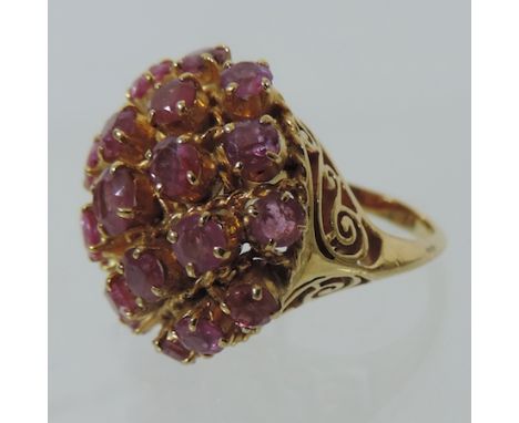 An unmarked gold and ruby cluster ring, boxed