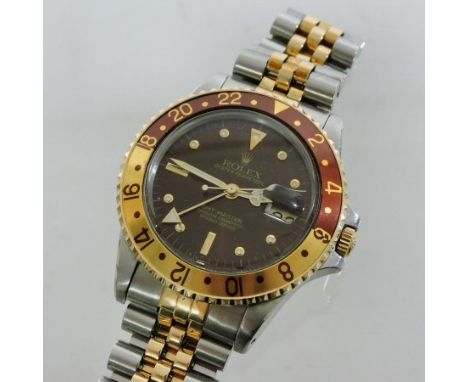 A Rolex Oyster Perpetual GMT Master steel and gold cased gentleman's chronometer wristwatch, with a black dial and flexible b