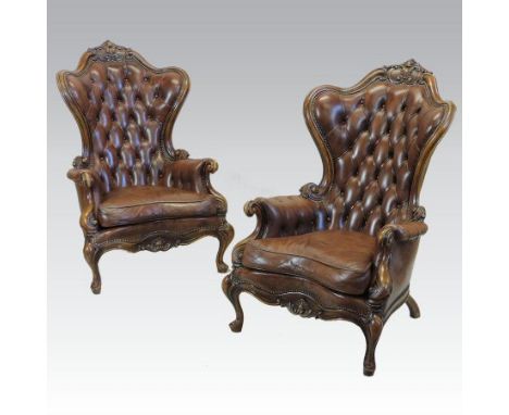 A pair of large Victorian style brown upholstered button back show frame armchairs, on cabriole legs, together with a similar