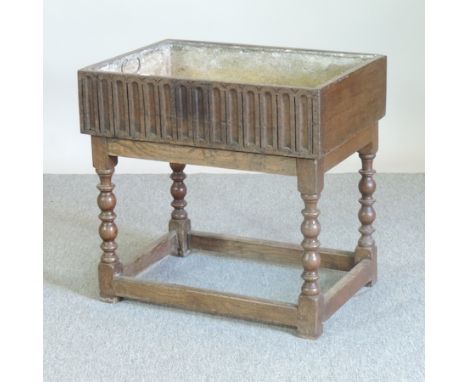 An 18th century carved oak planter, with a zinc liner, 64cm