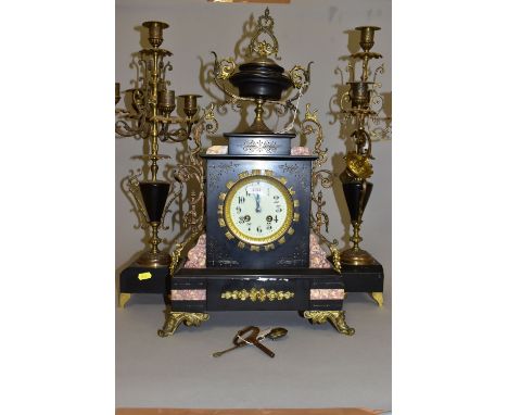 A LATE 19TH CENTURY BLACK SLATE, MARBLE AND GILT METAL CLOCK GARNITURE, the clock with urn shaped surmount and scrolling side