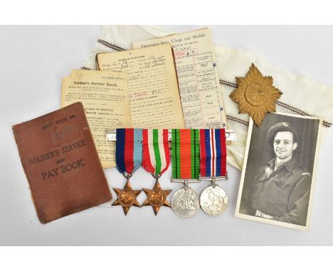 A GROUP OF FOUR WORLD WAR TWO MEDALS, including the 1939-45,Italy Stars, Defence &amp; War Medal on a wearing bar, together w