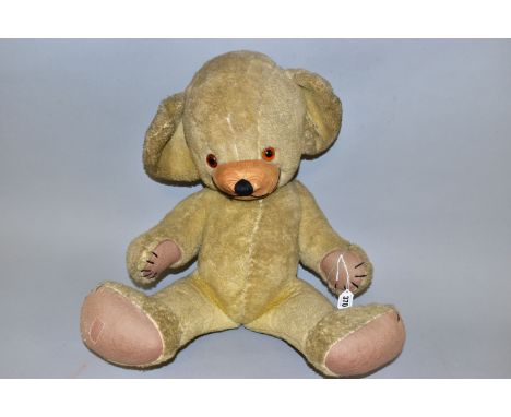 A MERRYTHOUGHT CHEEKY BEAR, C.1950'S/1960'S,  amber and black glass eyes, bell to left ear, velvet muzzle with slight damage 