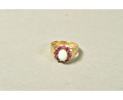 A 9CT GOLD OPAL AND PINK SAPPHIRE CLUSTER RING, the central oval opal cabochon within a circular pink sapphire surround, 9ct 