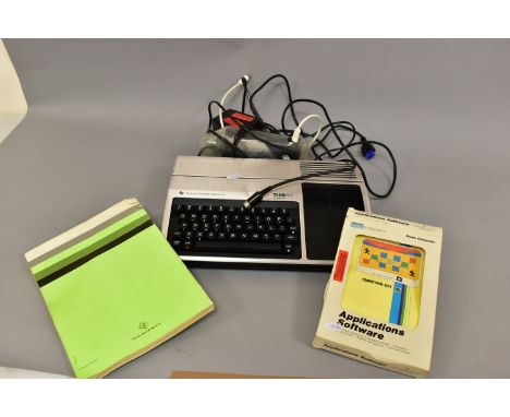 A TEXAS INTRUMENTS TI-99 4A VINTAGE PERSONAL COMPUTER with power supply, PHA 2036 modulator, manual and Tomb City software in