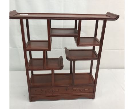 A Chinese hardwood netsuke display stand