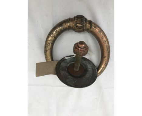 A heavy brass door knocker