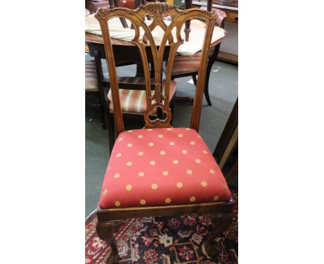 A set of ten reproduction Chippendale design dining chairs, eight singles and two open arm carvers. On cabriole front support