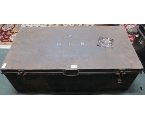A vintage metal travel trunk bearing initials HGB to the lid