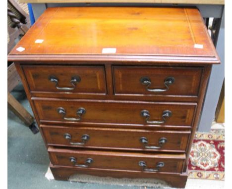 A compact set of two short over three long drawers