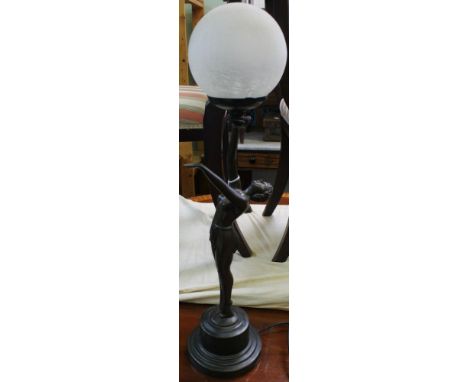 An Art Deco design figurative table lamp, modelled as a bronzed lady, supporting an opaque crackle glass globe shade, 68cm hi