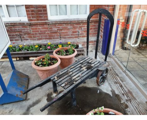 A vintage railway oak and iron luggage hand cart, with iron bound spoked wheels, length 154cm. This was used for the flower d