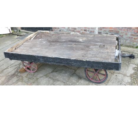 A vintage railway luggage trailer, with painted wooden decking to cast iron wheels, 225 x 135cm. This was used for many years