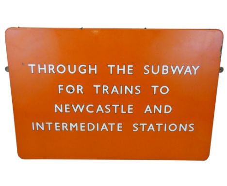 A single sided enamel B. R. (NE) sign, in light tangerine, 'Through the Subway for Trains to Newcastle and Intermediate Stati