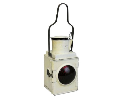 A locomotive headlamp with red bullseye lens, complete with inspection window, carry handle, vessel and burner, height 52cm.