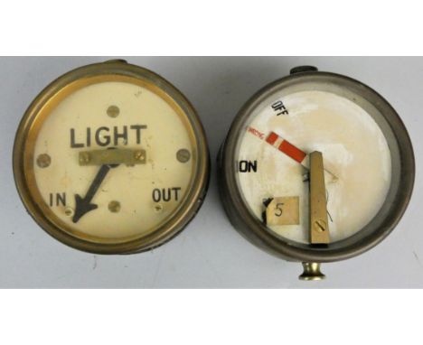 A Light In/Out gauge, diameter 10cm, together with another gauge marked 'On Wrong Off', lacking glass cover, diameter 10cm (2