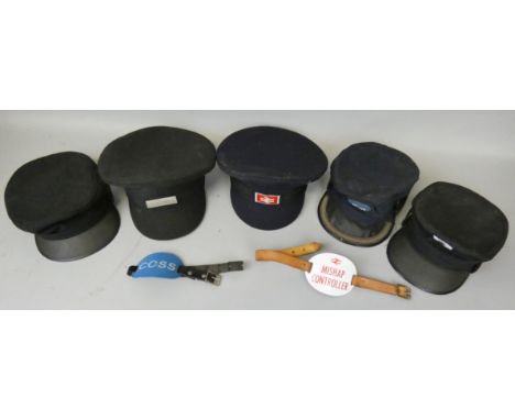 Five various railway caps, together with two enamel arm bands.