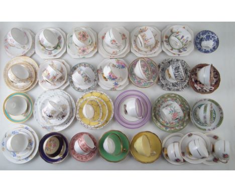 Twenty eight cups and saucers/ trios in various pattern by Birks &amp; Rawlins and Carlton ware Condition reports are not ava