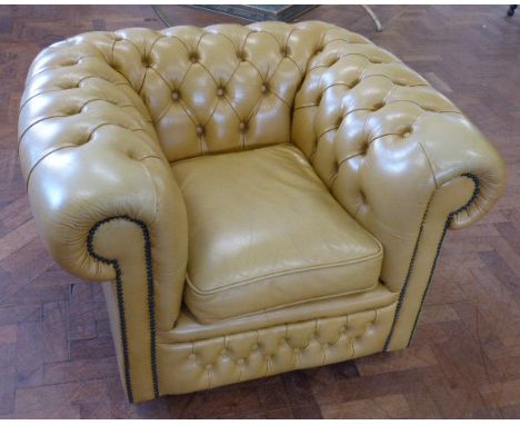 Light tan leather Chesterfield chair.