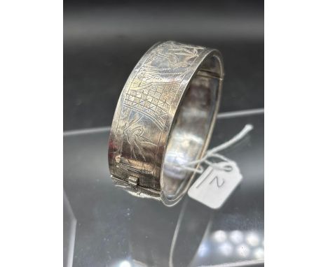 A wide engraved silver bangle 20.7 gms