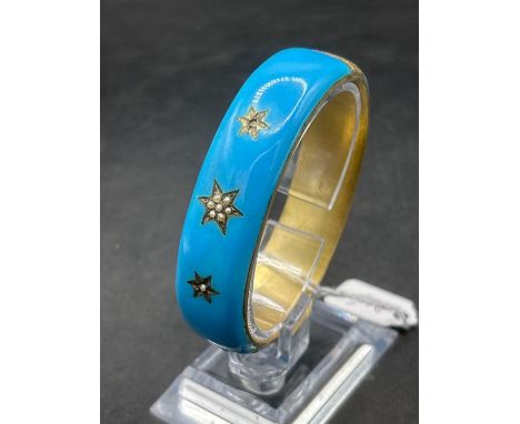 A blue enamel and silver gilt Victorian bangle set with a gem stone 2.5 inch diameter