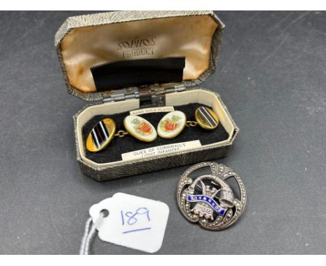 A silver brooch and pair of cufflinks