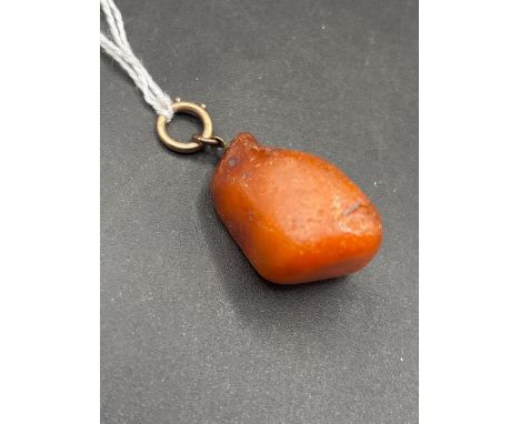A gold bolt mounted amber nugget 9.6 gms  