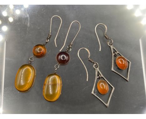 Two pairs of silver and amber earrings