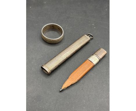 A silver pencil holder and ring