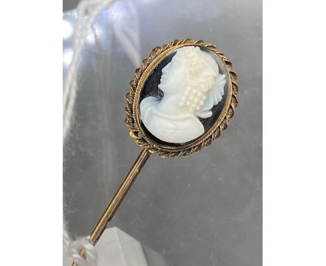 A gold mounted stick pin with hard stone cameo