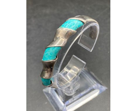 A silver and turquoise bangle 27 gms