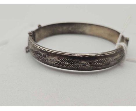 A engine turned silver bangle