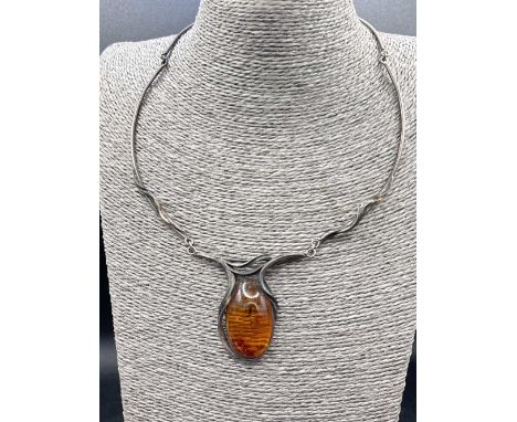 Silver 1970’s pendant necklace set with a large cabochon amber