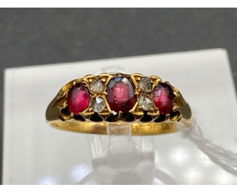 A seven stone ruby and diamond ring 18ct gold size P 2.8 gms