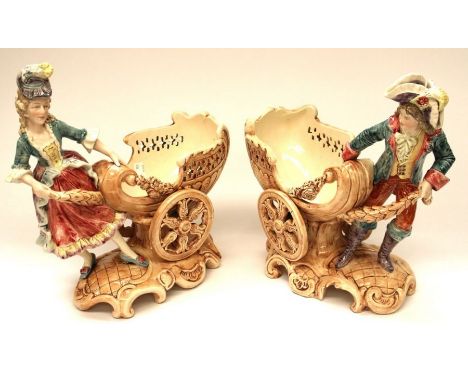 A collection of early 20th century German figures together with a Victorian ruby glass table lustre.