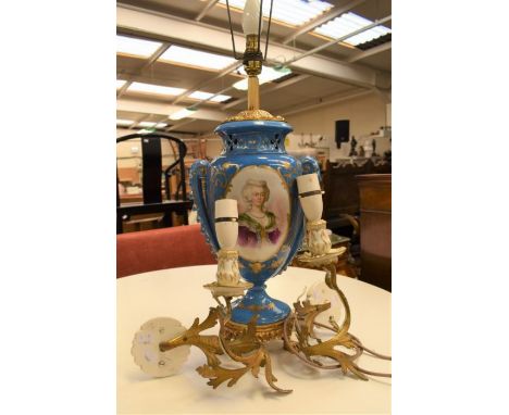 A large blue ceramic urn with gilt brass footed base and fitted lamp to top, gilding and portrait, floral decoration to side,