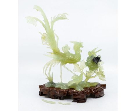 A Chinese carved pale jade figural group of three exotic birds perched with a butterfly resting on peony, 28cm high overall, 