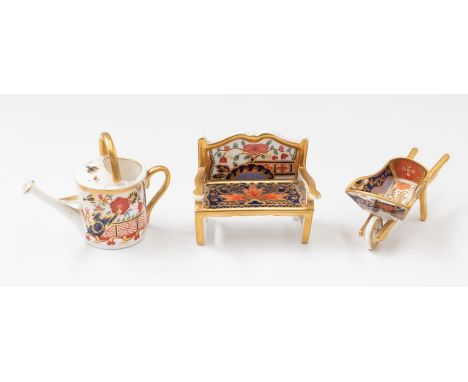 Royal Crown Derby miniature wheelbarrow, watering can and bench (all second quality).