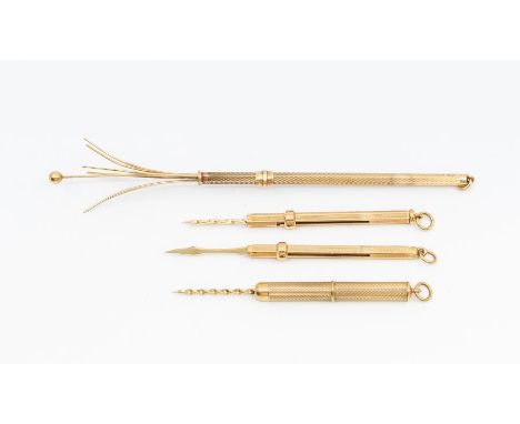 A collection of three 9ct gold tooth picks, comprising two of hexagonal form, one tubular form all with engine turned decorat