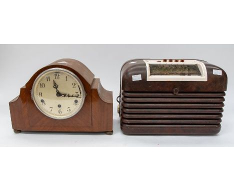 A Bush Bakelite 1950s table-top radio, together with a 1950 wooden mantel clock.