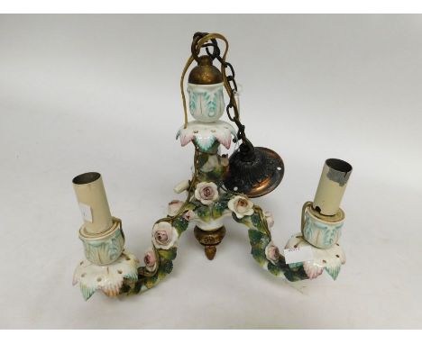An early 20th Century Continental three branched porcelain candlestick, converted to a ceiling light