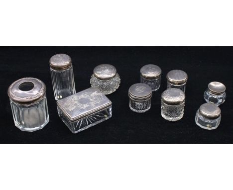 A collection of silver topped dressing table boxes/bottles to include; a rectangular cut glass Victorian silver topped box, a