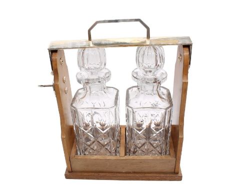 A two bottle cut glass tantalus&nbsp;
