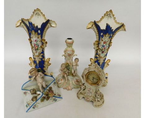 A pair of 19th century continental porcelain vases, a late 19th century ornamental candlestick and a clock with cherub detail