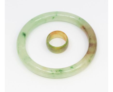 A jade type bangle, width approx 10mm, internal diameter approx 65mm, along with a similar ring, width approx 12mm, size S, c
