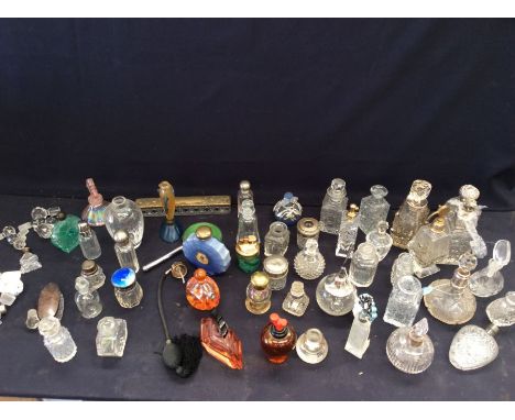 A collection of mixed glass perfume bottles, boxes, lighter and fish shaped vase, to include a Christian Dior 'Malachite' pat