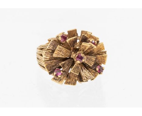 A ruby and diamond 9ct gold stylized ring circa 1970s, comprising undulating textured gold details with overlaid claw set rou