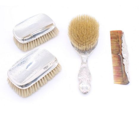 A collection of silver dressing table items to include; a pair of planished silver topped clothes brushes, both with vacant c